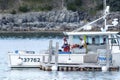 Lobstermen on a fishing boat sorting their catch of the day Royalty Free Stock Photo